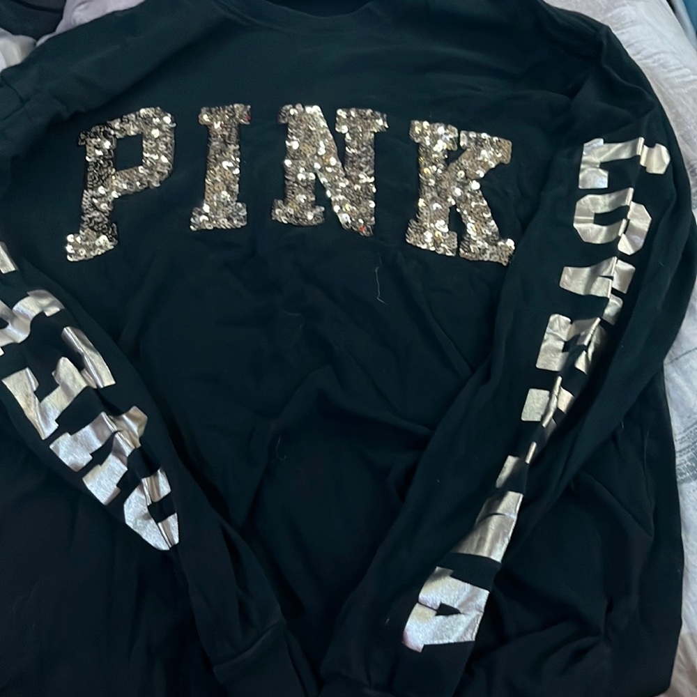 A Victoria’s Secret pink sweater made of 100% cotton